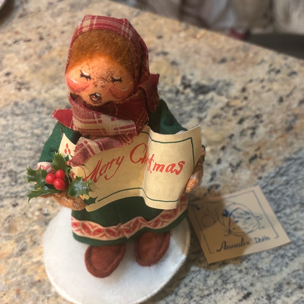 Holiday Caroler Figurine with Plaid Scarf. Anna Lee figurine